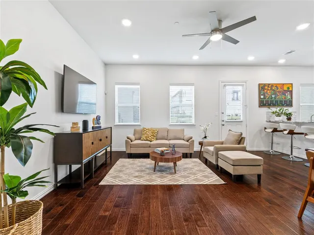 a living room with furniture and wooden floor