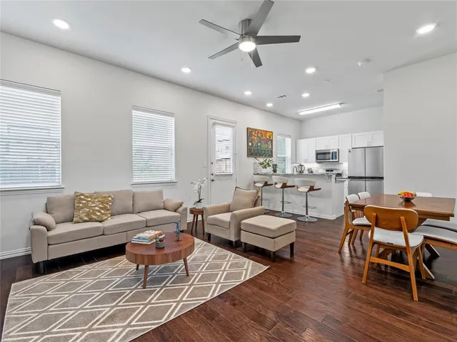 a living room with furniture wooden floor and window