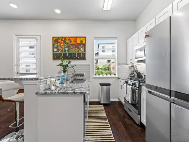 a kitchen with a sink stove and refrigerator
