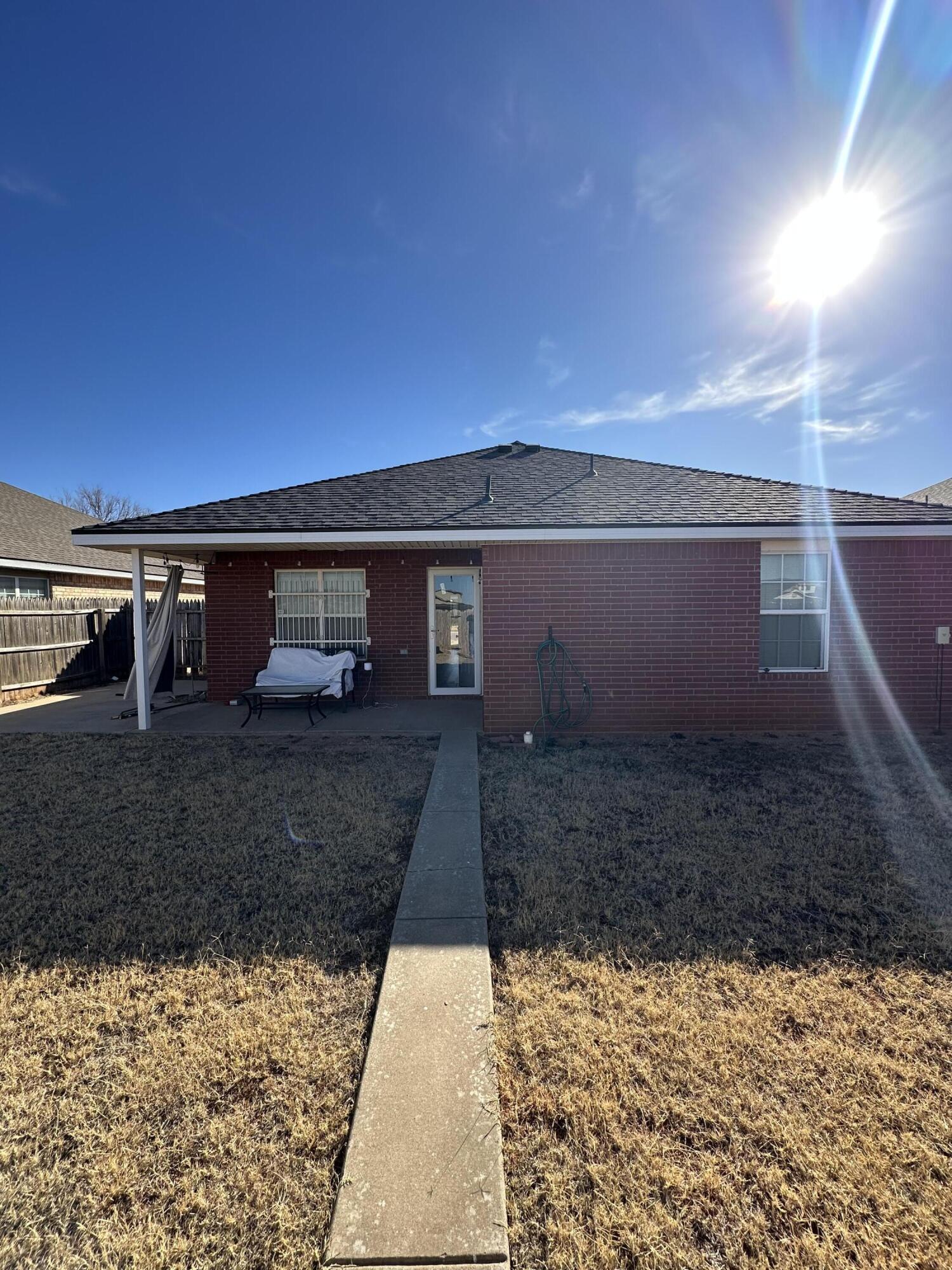 6514 85th Street Lubbock, TX 79424 - Photo 13 of 13 a view of a yard with wooden fence