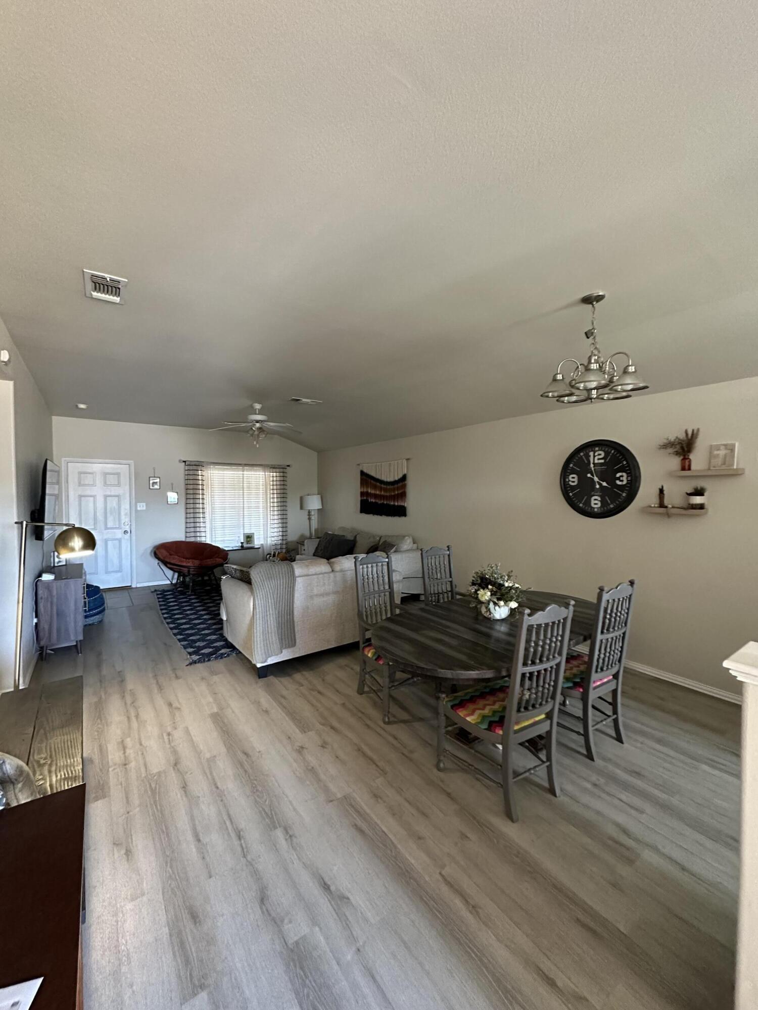 6514 85th Street Lubbock, TX 79424 - Photo 2 of 13 a living room with furniture and a wooden floor