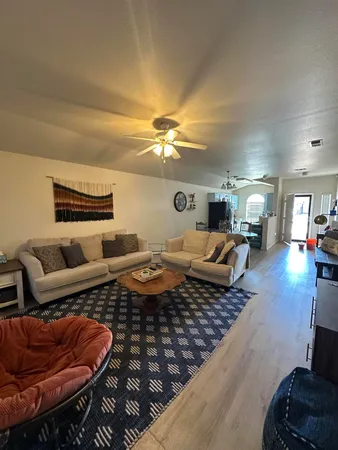 a living room with furniture and a chandelier