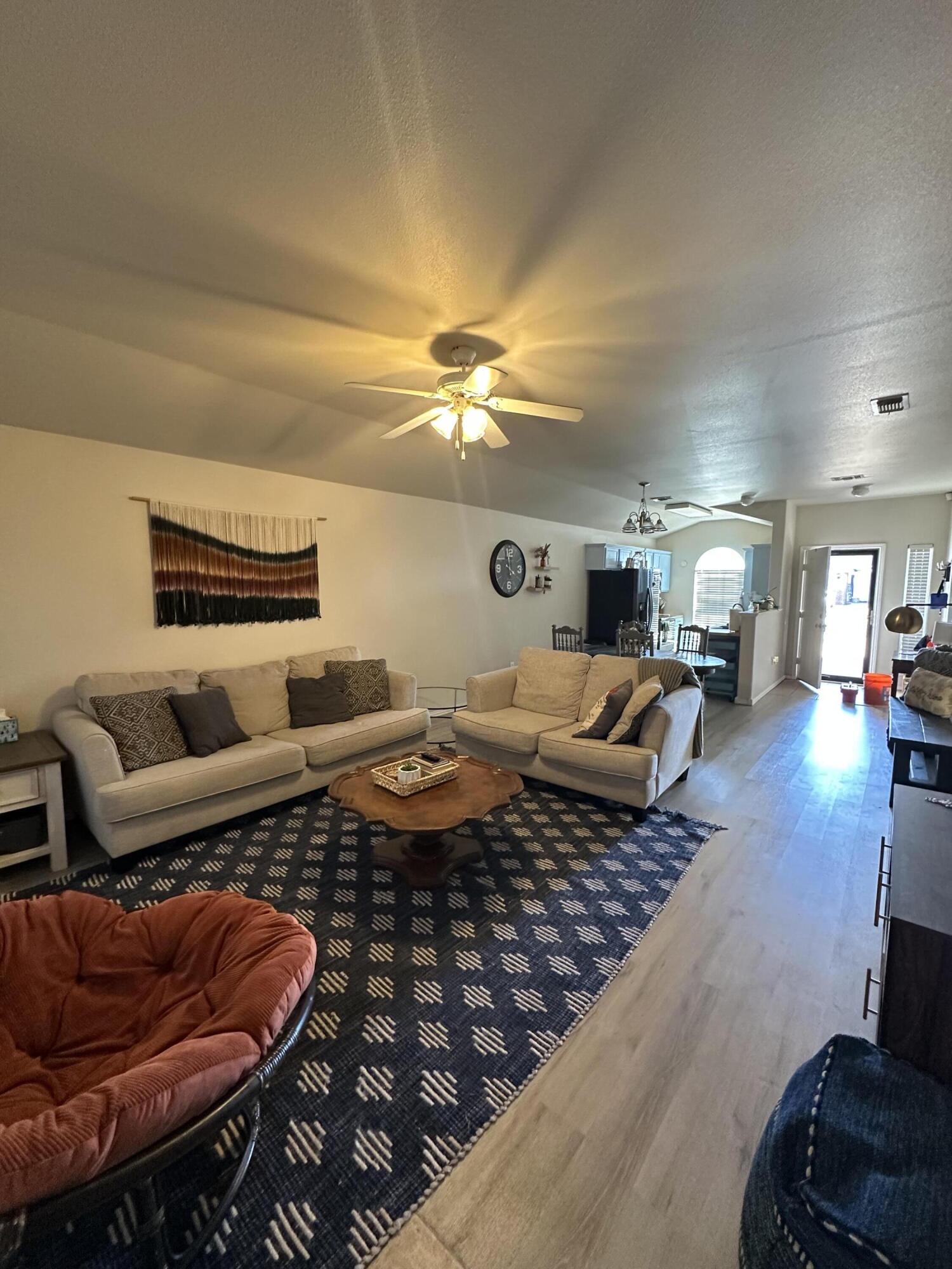 6514 85th Street Lubbock, TX 79424 - Photo 4 of 13 a living room with furniture and a chandelier