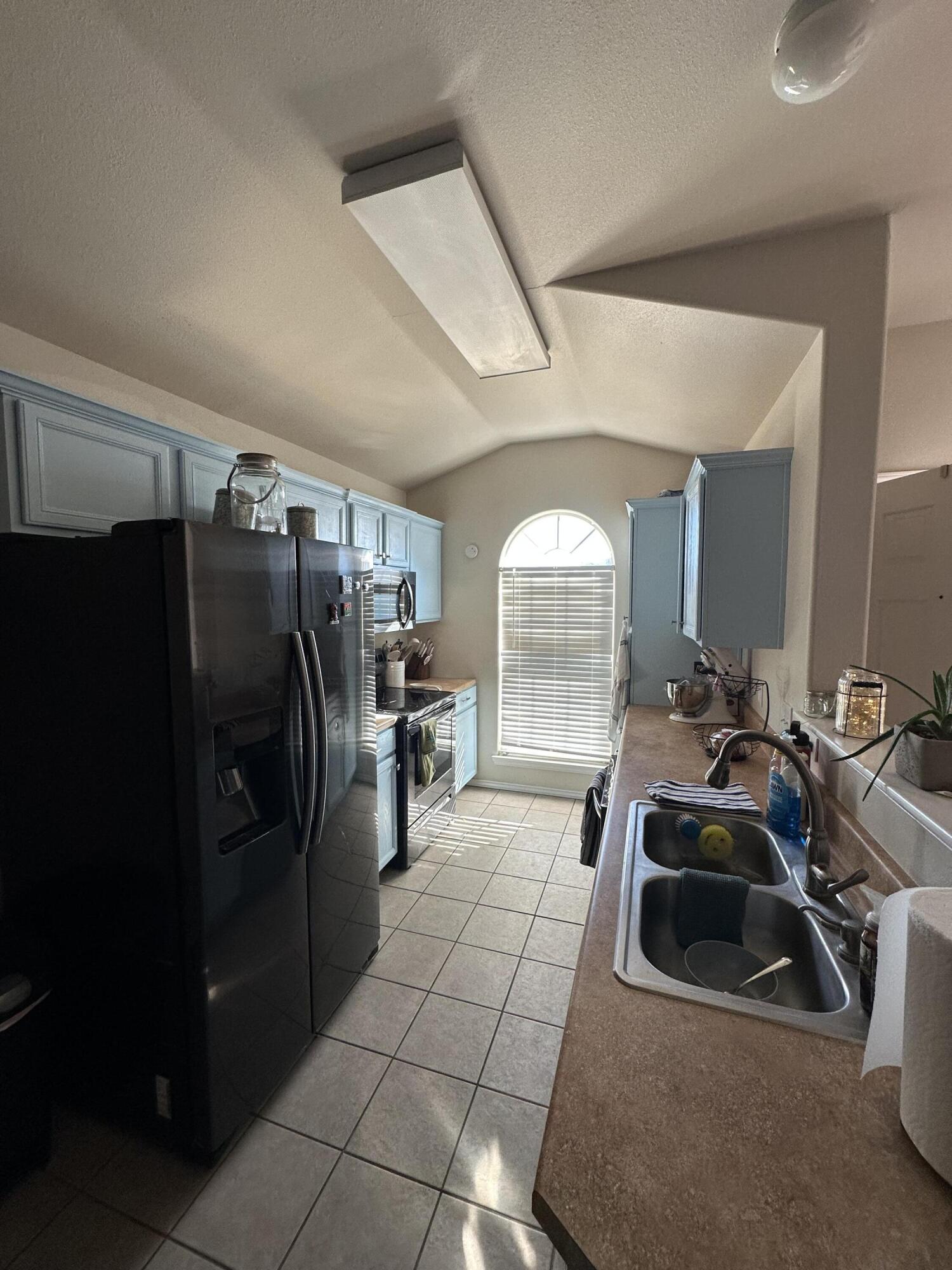 6514 85th Street Lubbock, TX 79424 - Photo 5 of 13 a room with gym equipment and a large window
