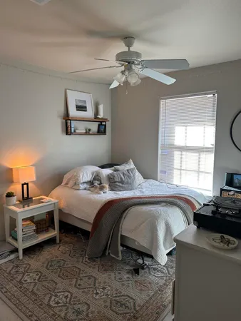 a bedroom with a bed and a window