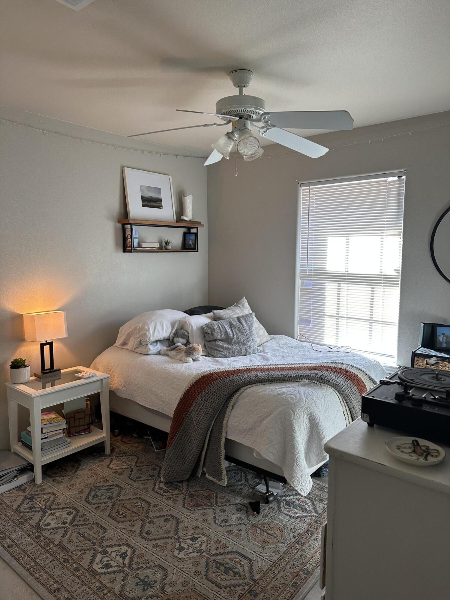 6514 85th Street Lubbock, TX 79424 - Photo 6 of 13 a bedroom with a bed and a window