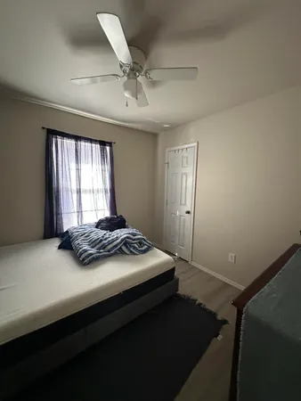 a bedroom with a bed and window