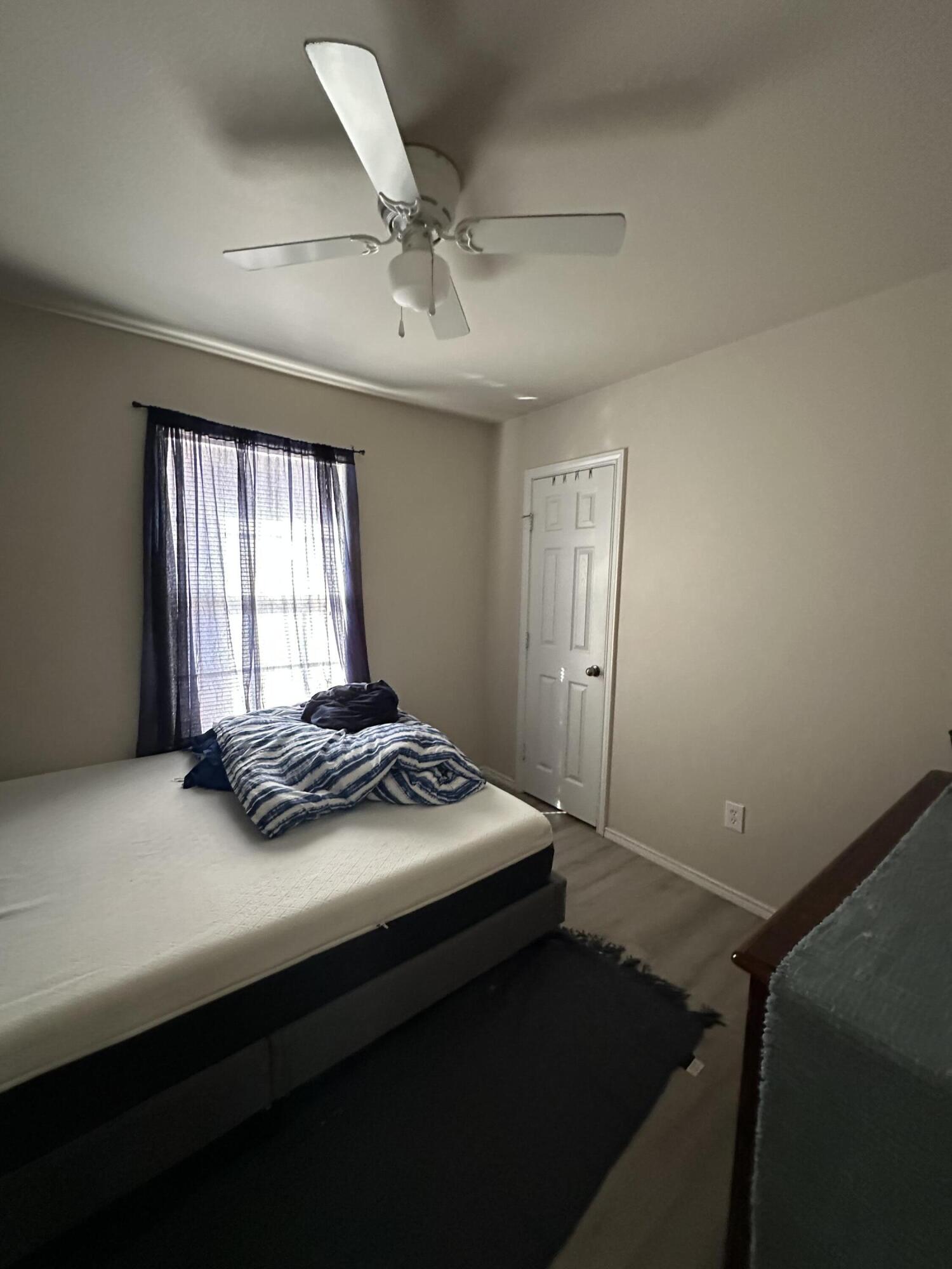 6514 85th Street Lubbock, TX 79424 - Photo 8 of 13 a bedroom with a bed and window