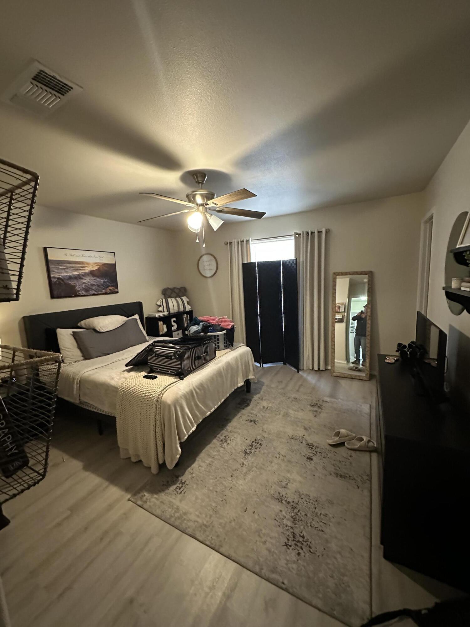 6514 85th Street Lubbock, TX 79424 - Photo 10 of 13 a spacious bedroom with a bed and dresser