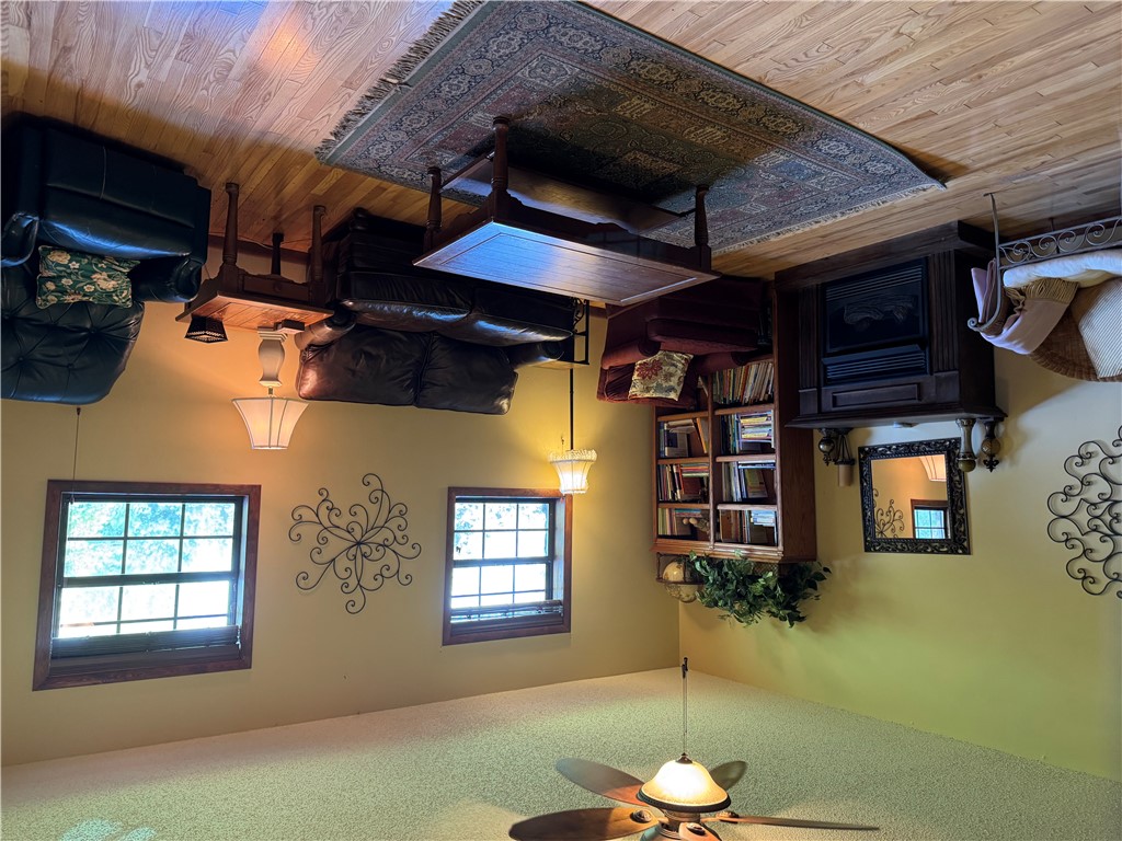 9643 Erbie Cutoff Road South Harrison, AR 72601 - Photo 12 of 41 Living area featuring wood-finish flooring, a decorative fireplace, and a ceiling fan with integrated lighting