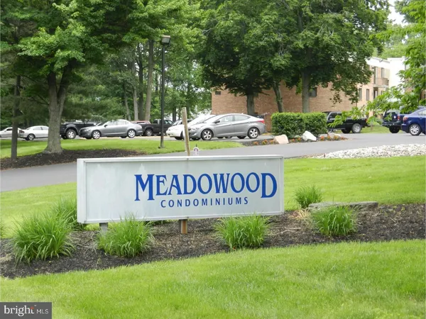 a view of outdoor space with sign board and tree