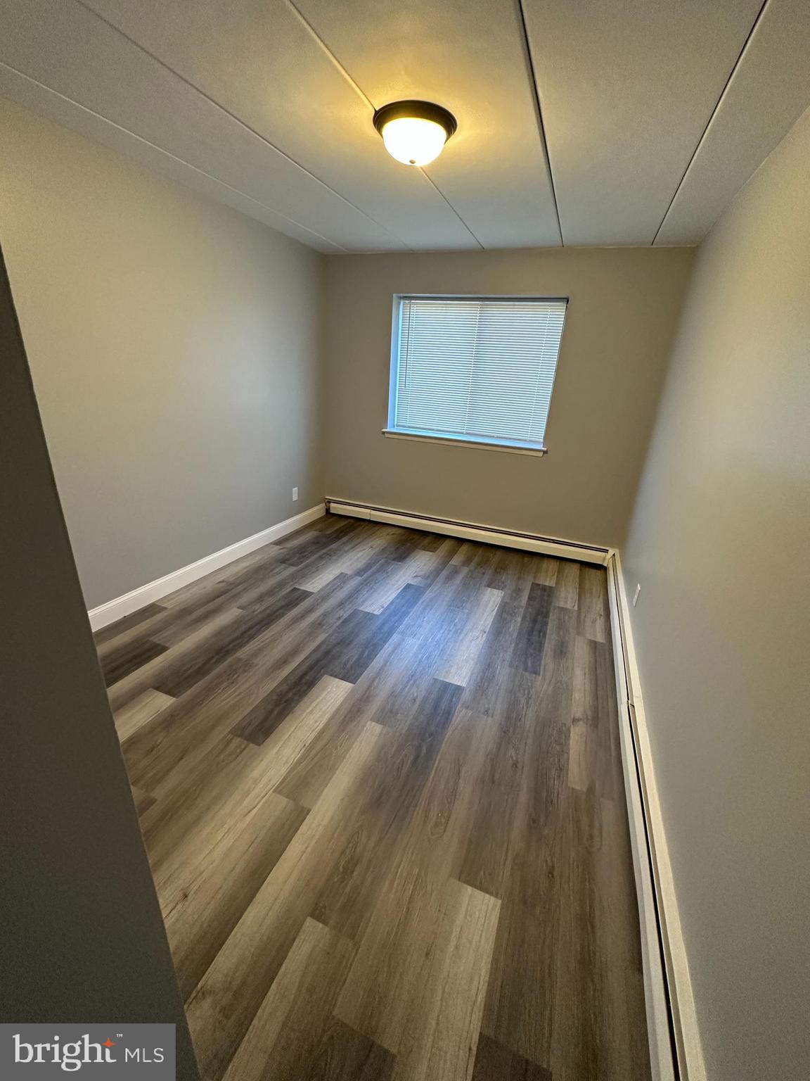 1575 West Street Road, Unit 922 Warminster, PA 18974 - Photo 12 of 16 en empty room with wooden floor