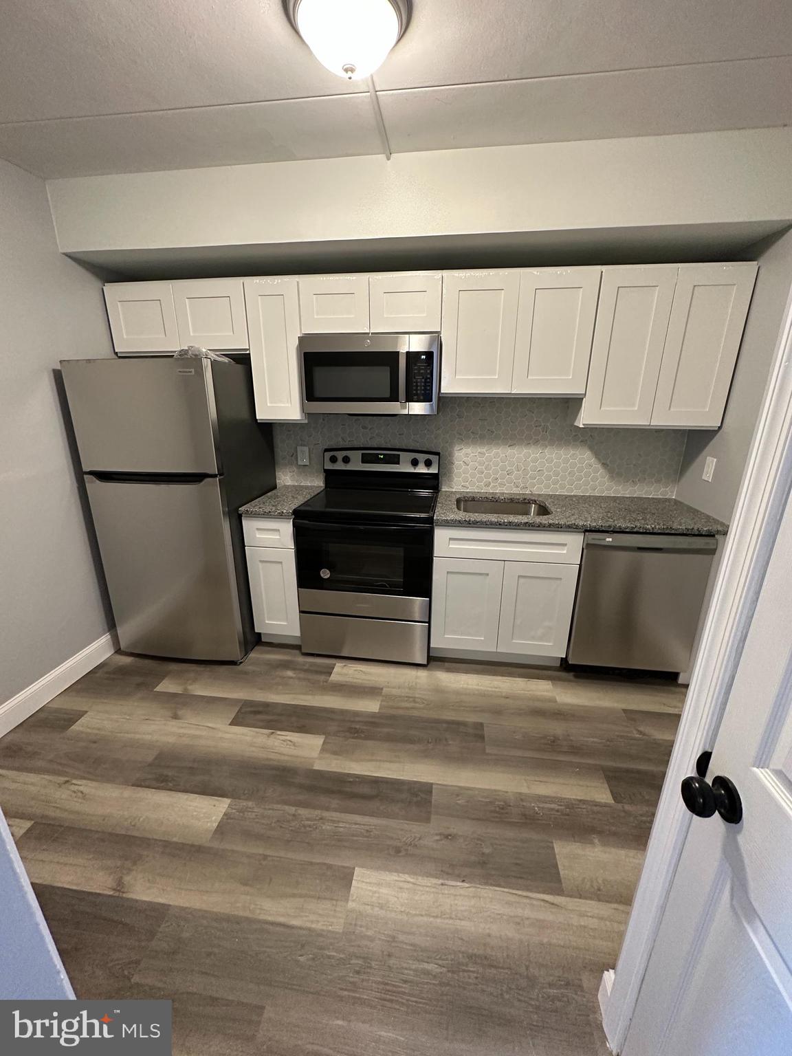 1575 West Street Road, Unit 922 Warminster, PA 18974 - Photo 3 of 16 a kitchen with a refrigerator and a stove