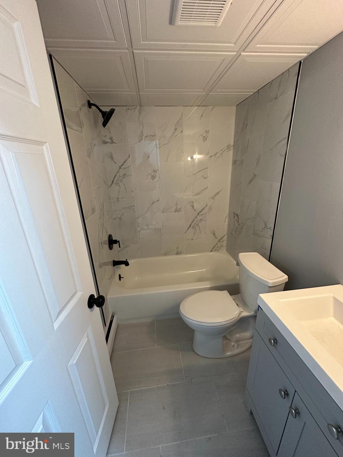 1575 West Street Road, Unit 922 Warminster, PA 18974 - Photo 7 of 16 a bathroom with a granite countertop sink toilet and shower