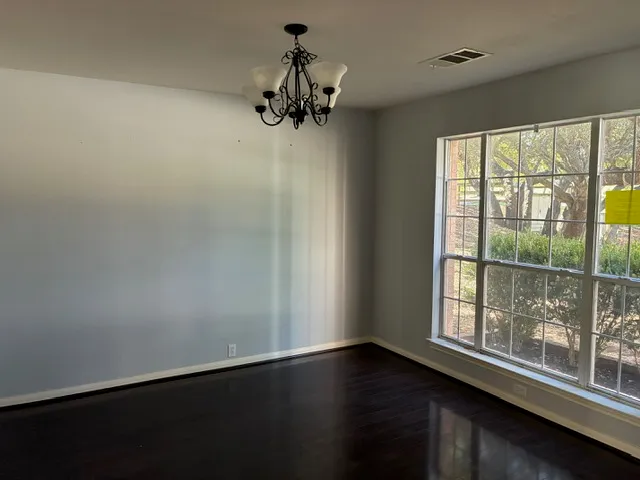 a view of a room with wooden floor and windows
