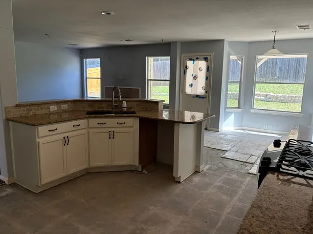 a kitchen with a sink stove and cabinets