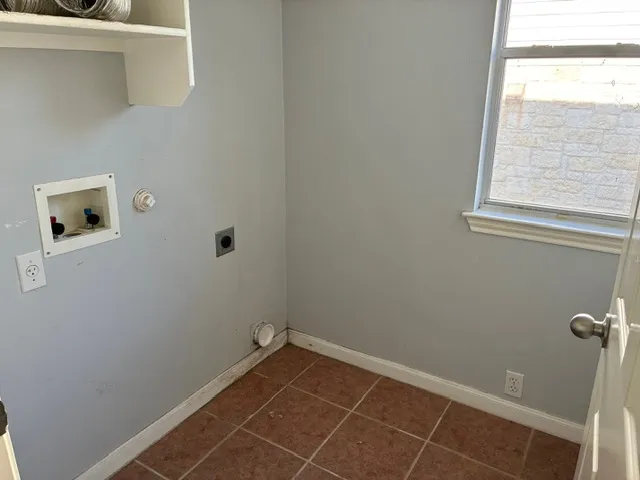 a view of a room with rack on the wall and a window