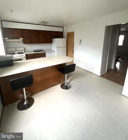 a room with a bed and a dresser