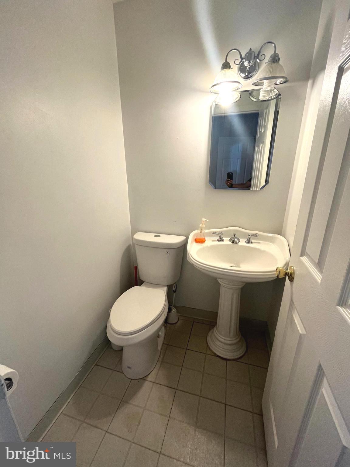 2943 Sunset Lane Suitland, MD 20746 - Photo 19 of 24 a white toilet sitting next to a bathroom sink