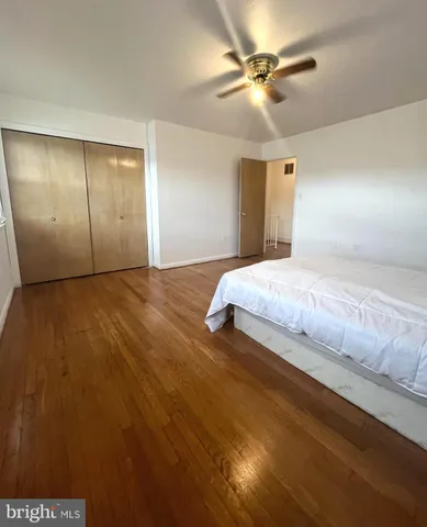 a bedroom with a bed and a ceiling fan