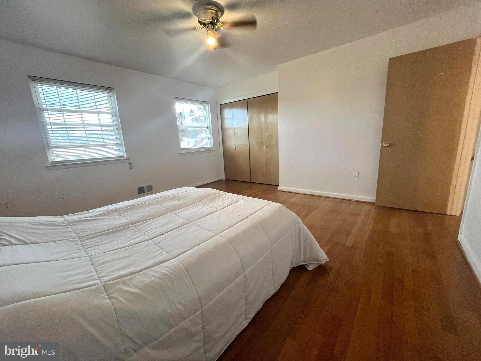 2943 Sunset Lane Suitland, MD 20746 - Photo 9 of 24 a bedroom with a bed and wooden floor
