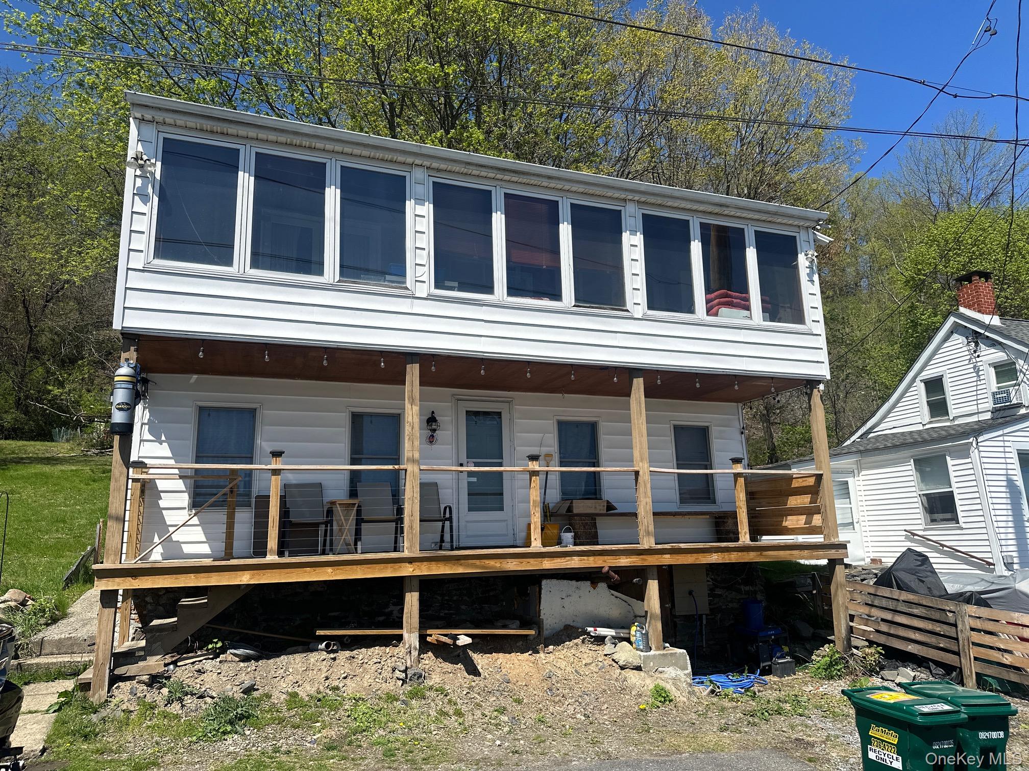 View of front of house with a wooden deck