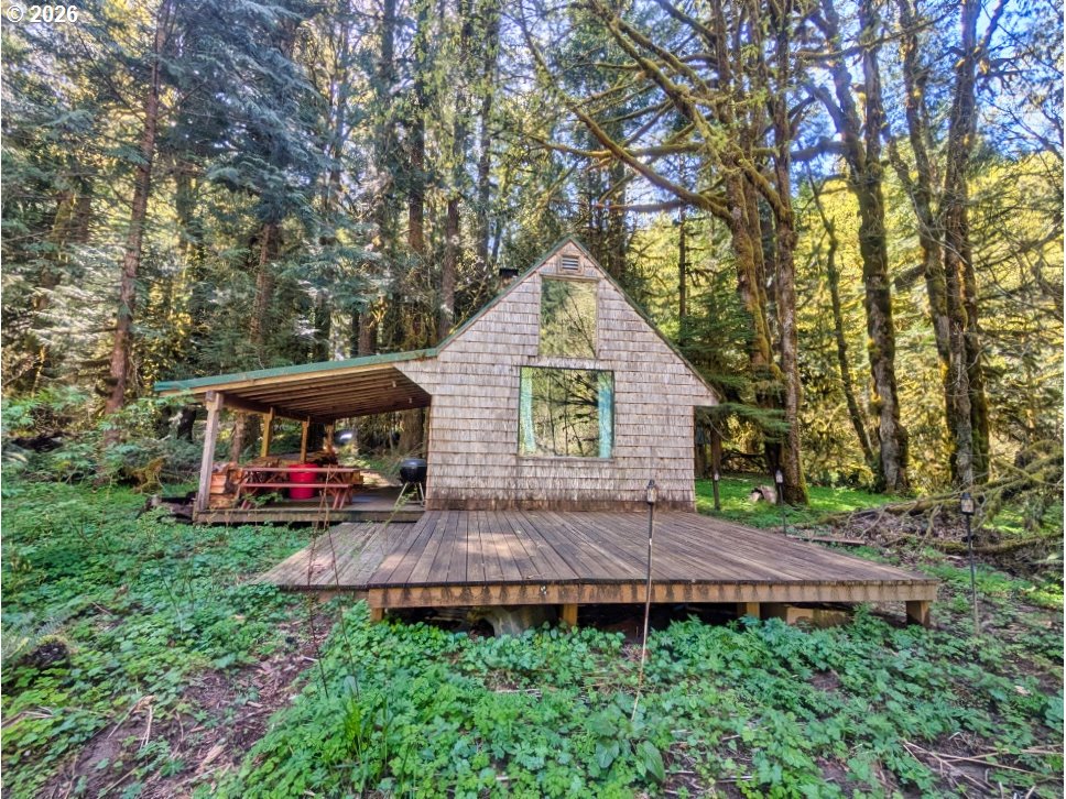 30460 Road 12 Rhododendron, OR 97049 - Photo 2 of 29 a view of a house with a small yard and a large tree