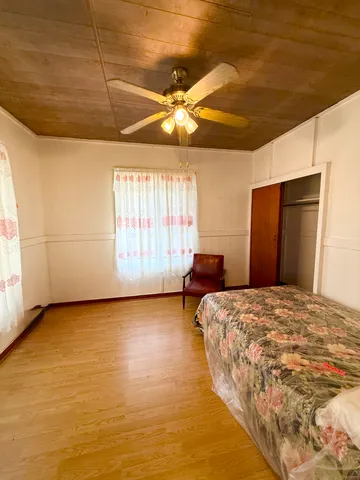 a spacious bedroom with a bed and a large window