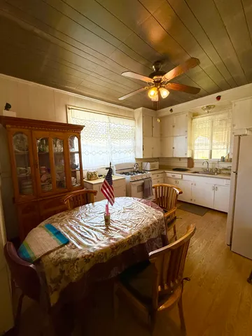 a view of a dining room with furniture and window