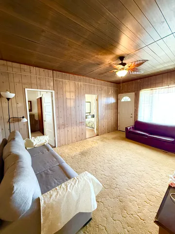 a spacious bedroom with a large bed and a large window