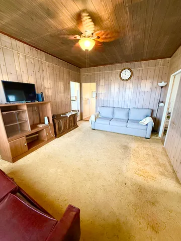 a bed room with a bed furniture and a flat screen tv