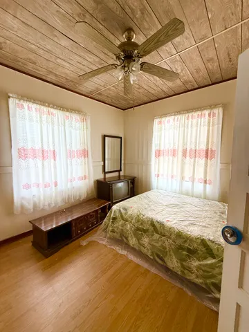 a spacious bedroom with a bed and window