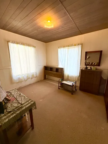 a bedroom with bed and window