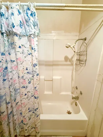 a bathroom with a bathtub and shower