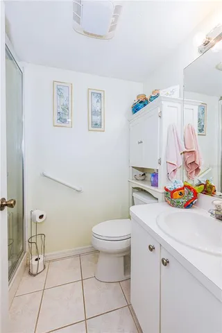 a bathroom with a sink a toilet and a shower