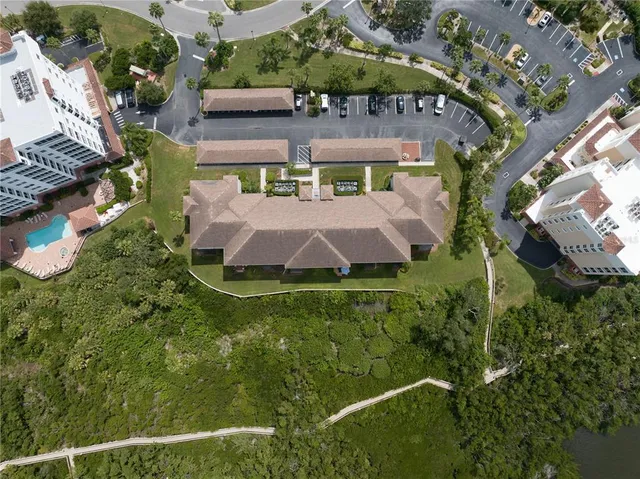 a view of a large building with a big yard and plants