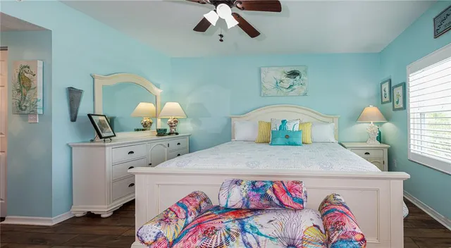 a bedroom with a large bed and a chandelier