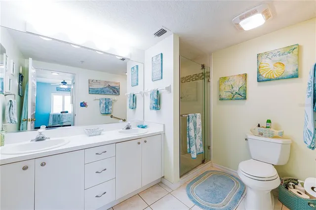a spacious bathroom with a toilet sink double vanity and tub