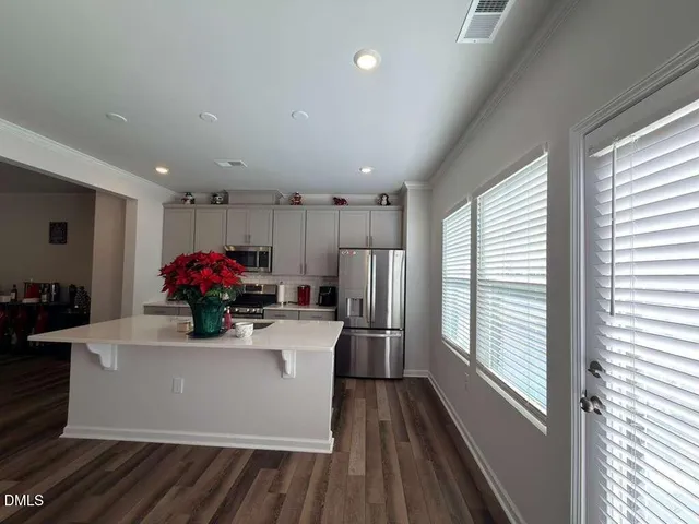 a view of a dining room with furniture a chandelier and wooden floor