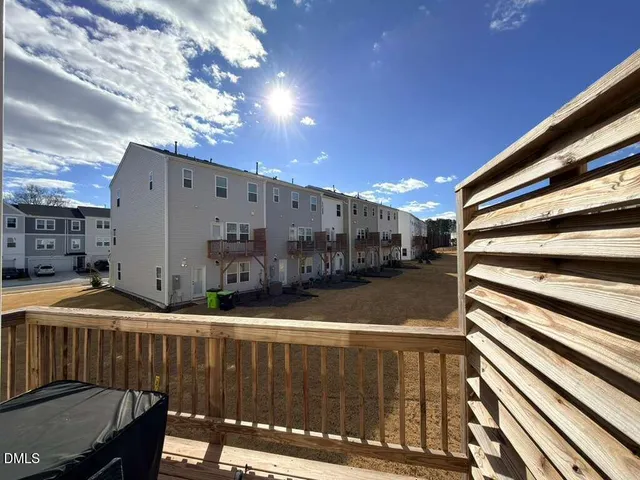 a view of street with wooden fence