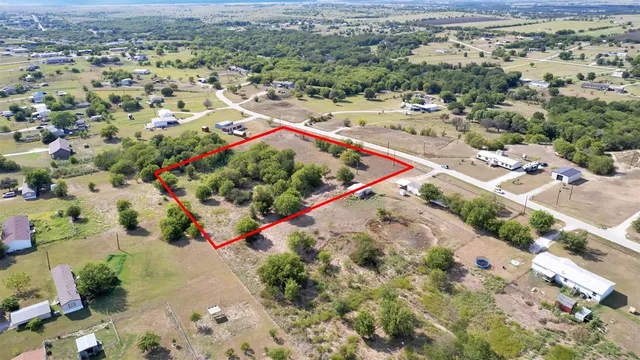 an aerial view of a house with a yard and garden