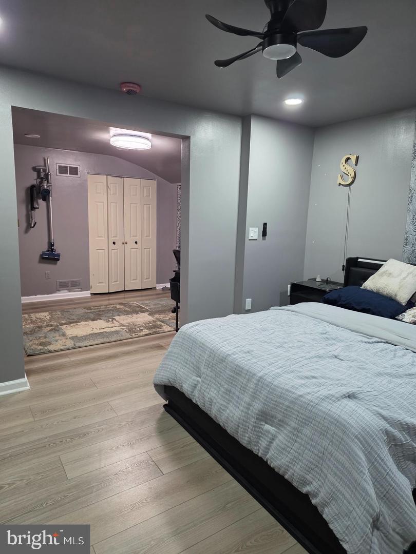 1407 Adamsview Road Baltimore, MD 21228 - Photo 19 of 40 a bedroom with a bed and a walk in closet