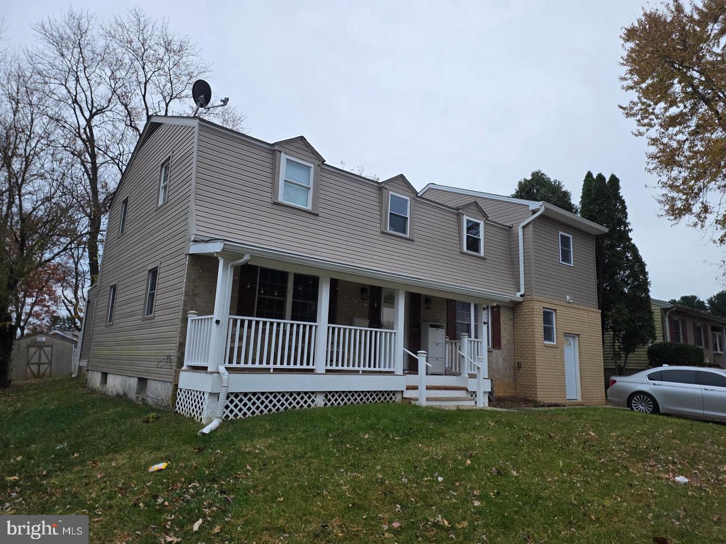 1407 Adamsview Road Baltimore, MD 21228 - Photo 3 of 40 a front view of a house with a garden
