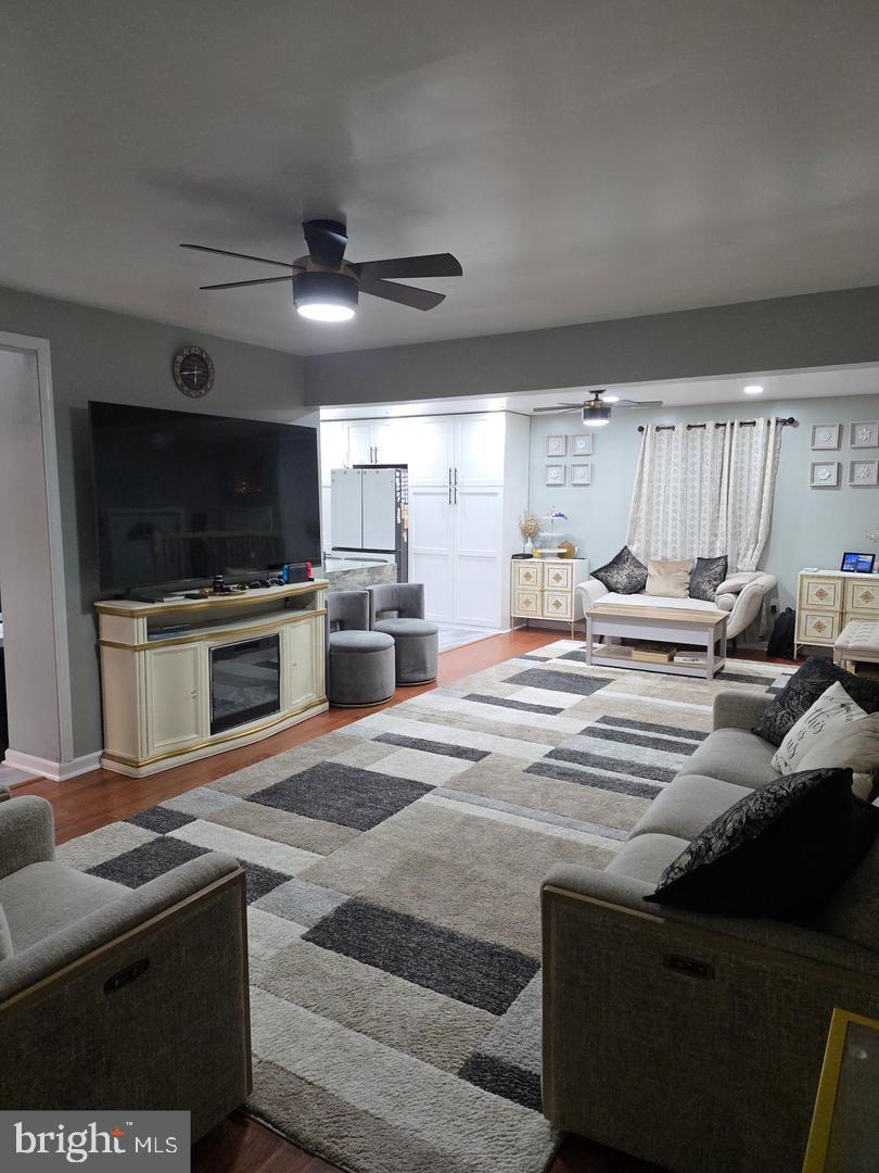 1407 Adamsview Road Baltimore, MD 21228 - Photo 7 of 40 a living room with stainless steel appliances furniture a fireplace and a flat screen tv