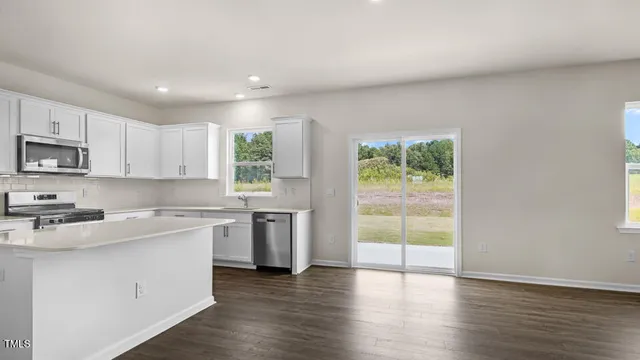 a kitchen with a stove a sink and a microwave