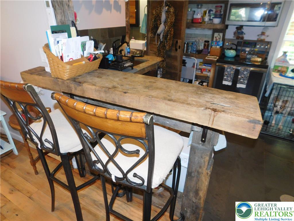41 Reeder Street Mount Pocono, PA 18344 - Photo 20 of 41 A rustic reclaimed wooden bar adds charm to the kitchen space.