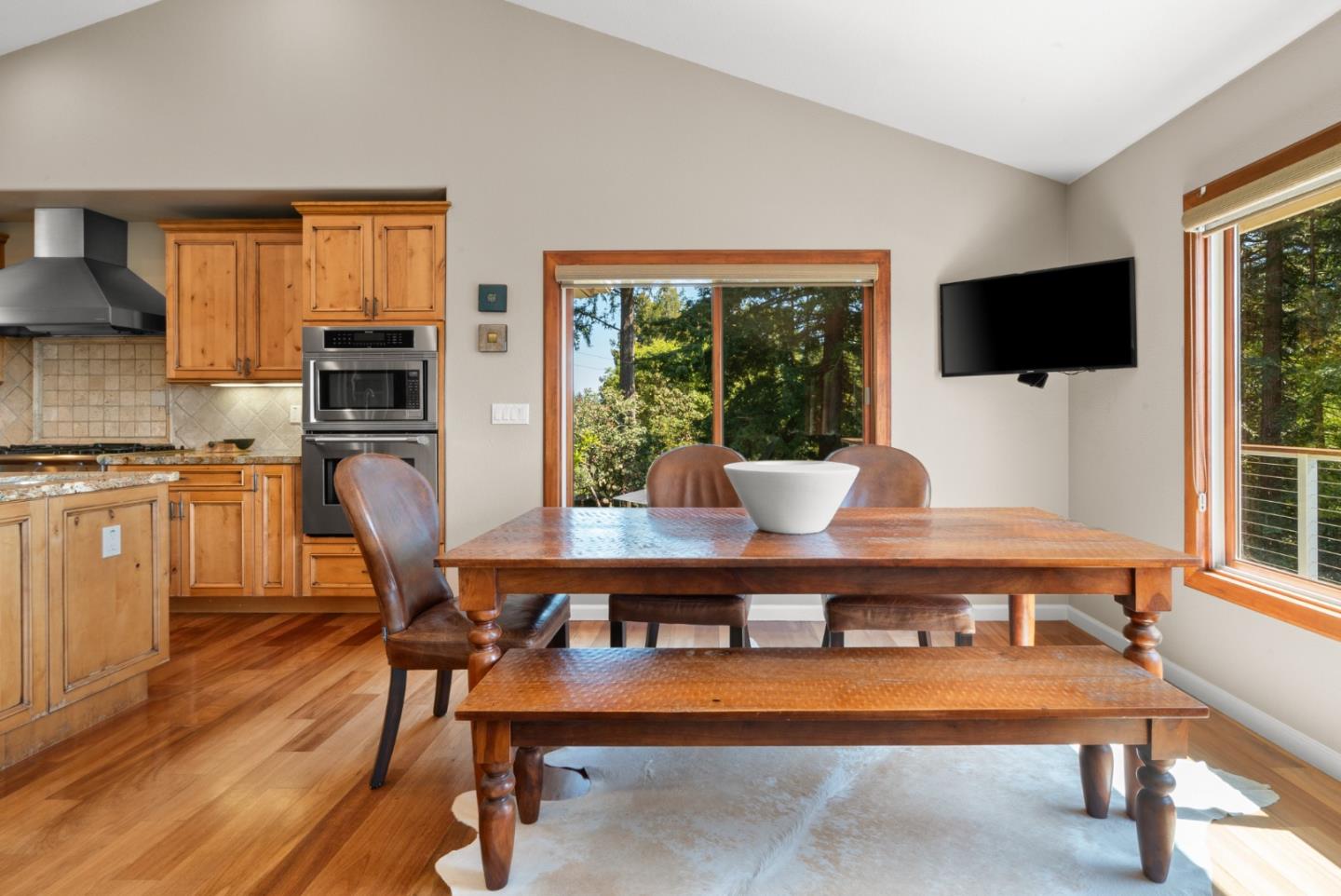 24101 Mountain Charlie Road Los Gatos, CA 95033 - Photo 21 of 59 a living room with furniture a flat screen tv and floor to ceiling window