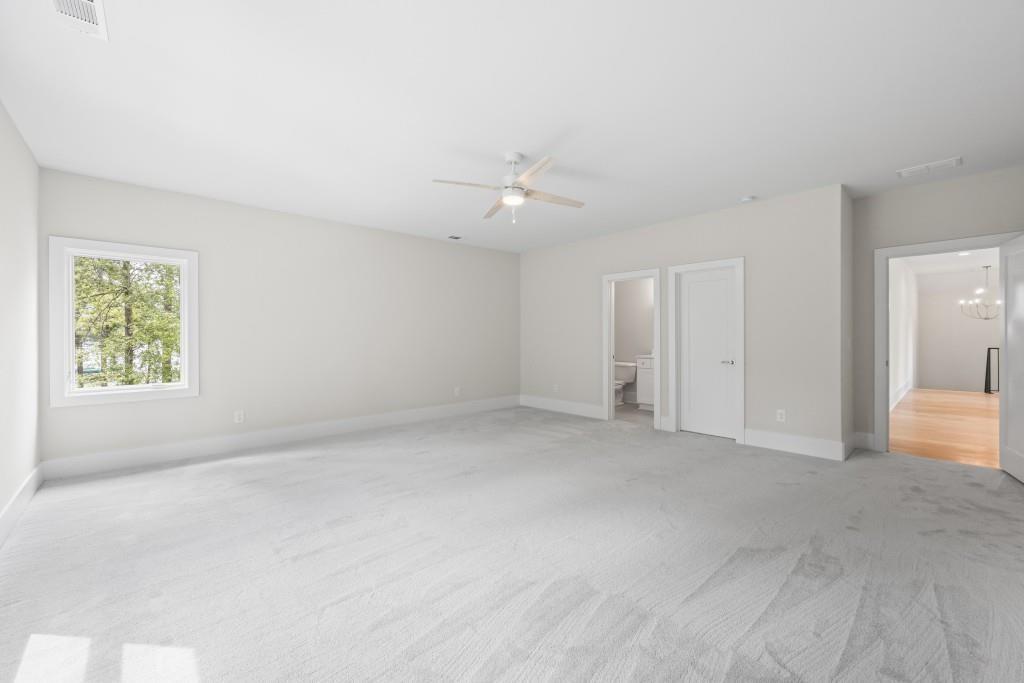 1301 Grayson Pointe Drive Buckhead, GA 30625 - Photo 36 of 56 an empty room with a window and a ceiling fan