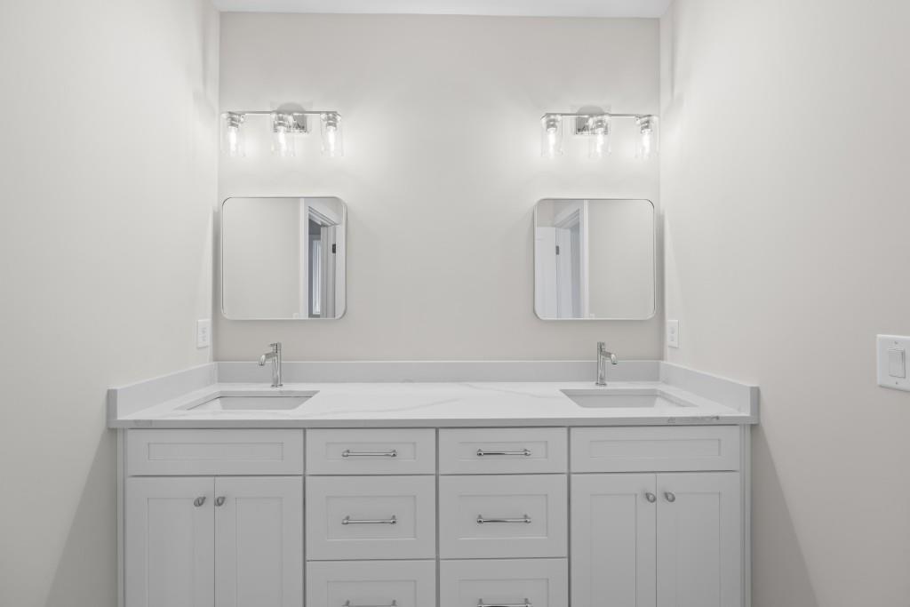 1301 Grayson Pointe Drive Buckhead, GA 30625 - Photo 42 of 56 a bathroom with double vanity sinks and a mirror