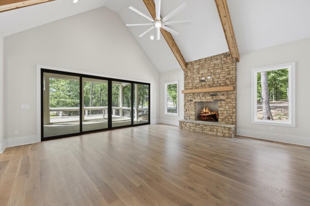 1301 Grayson Pointe Drive Buckhead, GA 30625 - Photo 9 of 56 wooden floor fireplace and windows in an empty room